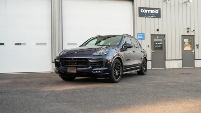 Dark Porsche Cayenne photographed outside the shop