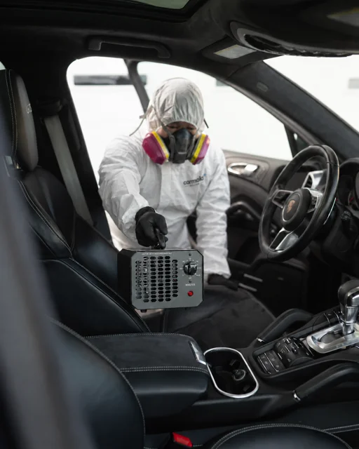 CarMold Boston technician wearing protective equipment inside a vehicle